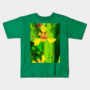 Yellow red lily blossom on green background Kids T-Shirt